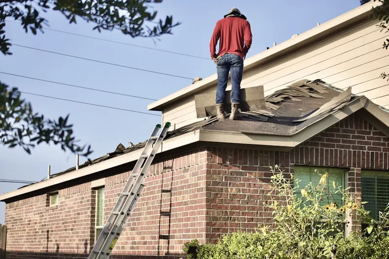 Professional roofer working on a residential roof in Brinkwood Estates